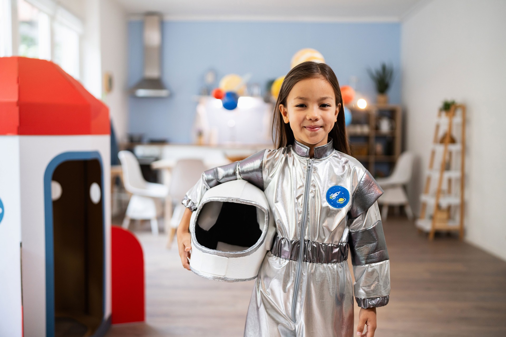 Portrait of a girl in space suit dreaming of becoming an astronaut one day